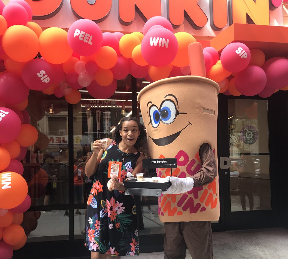 Balloon arch and the Dunkin' mascot at the NYC Social Club Dunkin' takeover